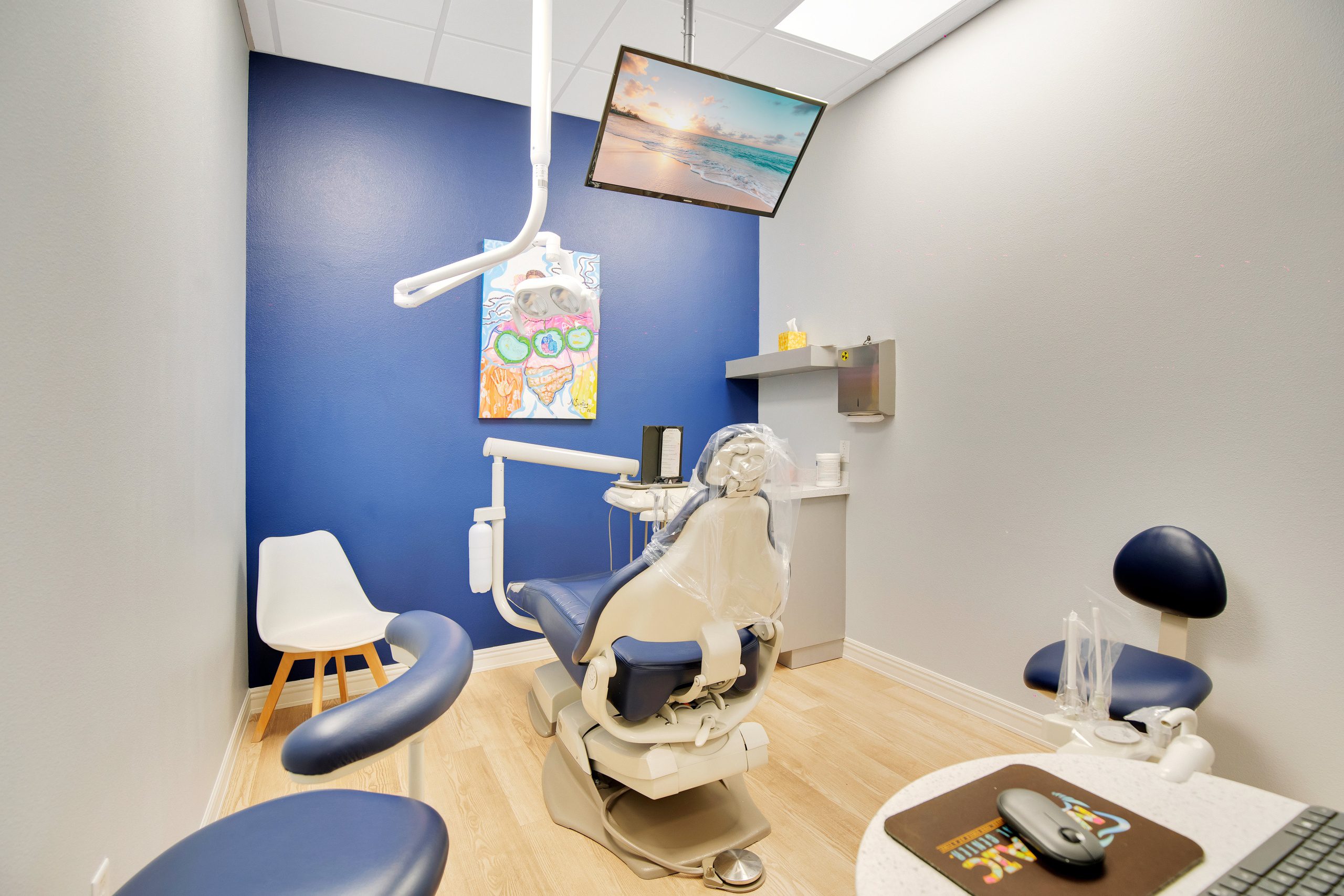 Dental treatment room with chairs and televisition