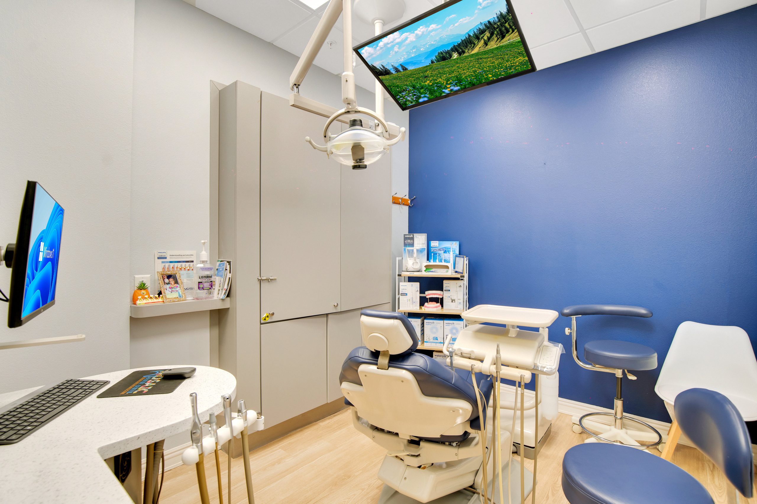 Overhead dental light and monitor screens.
