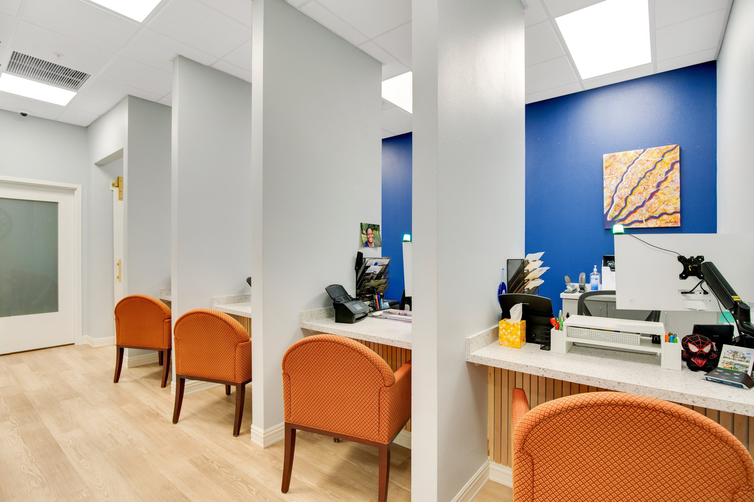 Open layout with vertical partitions providing privacy at each desk.